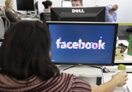 FILE -This Dec. 13, 2011 file photo, shows workers inside Facebook headquarters in Menlo Park, Calif. Facebook, the social network that changed 
