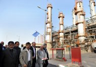Iranian President Mahmoud Ahmadinejad (centre) tours the Abadan oil refinery in Iran in 2011. Tehran will cut oil exports to more EU nations if they remain 