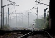 An Indian man walks on the railway tracks on a foggy morning in New Delhi in January 2012. Almost 15,000 people are killed every year crossing India's rail tracks in what a government report has described as an annual 