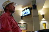 Antonio Gray watches a television in a Sydney pub as a news broadcast shows Australian Foreign Minister Kevin Rudd resigning, Wednesday, Feb. 22, 2012. Rudd announced his resignation during an early morning news conference in Washington, where he is visiting on official business.