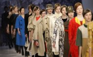 File photo of models presenting creations by Aquascutum. A Hong Kong company said it has agreed to buy the business and assets of troubled British luxury clothing maker Aquascutum for £15 million ($24.2 million).