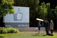 A television crew prepares for a broadcast in front of a 'like' sign outside Facebook headquarters in Menlo Park, California. Facebook stumbled in its first trading day Friday as shares ended barely above the starting price after a glitch-plagued market debut on the Nasdaq that failed to live up to the enormous hype. (AFP Photo/Stephen Lam)
