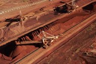 Image provided by BHP Billiton in February shows iron ore being stockpiled for export at Port Hedland in Western Australia. Global mining giant BHP Billiton on Wednesday reported a 15% increase in iron ore output in the June quarter, for a 12th consecutive annual production record. (AFP Photo/Bhp Billiton)